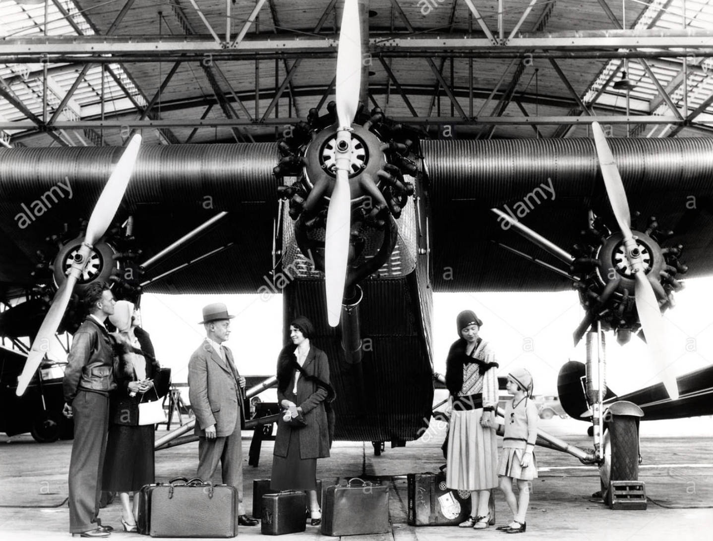 Group in Front of Tri-Motor Airplane Stock Photo